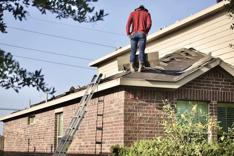 Professional roofer working on a residential roof in Fairfax Village